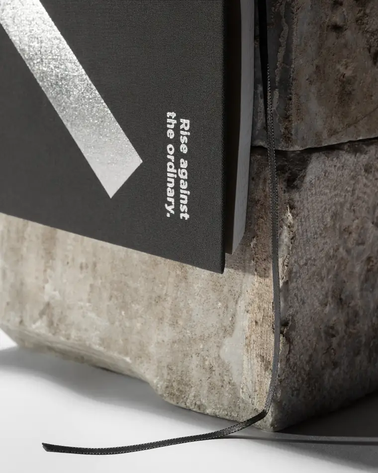 Close detail of the silver foil geometry on the notebook cover.