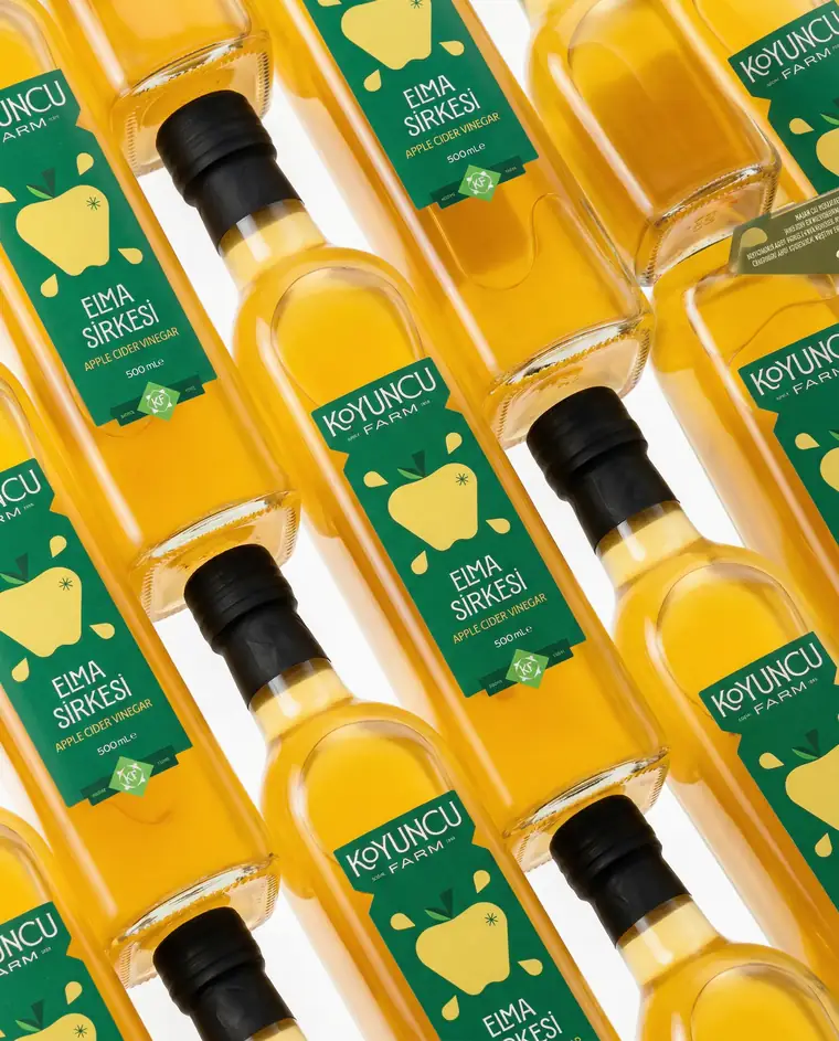 Repeating diagonal rows of Koyuncu Farm vinegar bottles.
