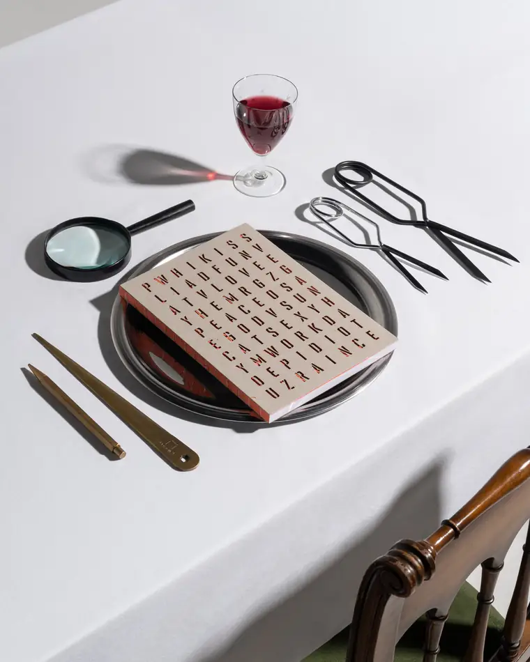 An orange word-search notebook on the same laid table.